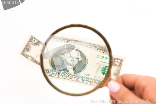 Image of Two dollars bill and magnifying glass