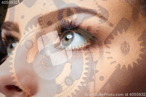 Image of Photo of woman eye and clockwork. Double exposure