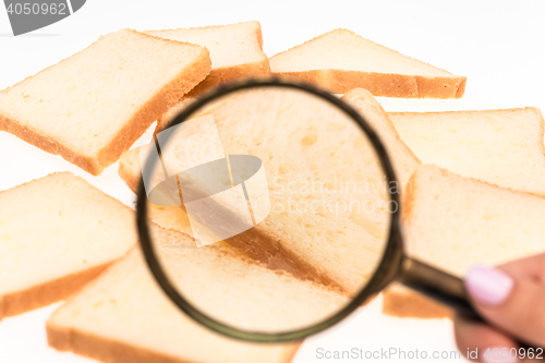 Image of View through a magnifying glass to toast bread on the table. Wheat.