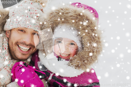 Image of happy family in winter clothes outdoors