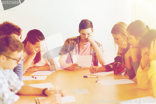 Image of group of students with papers