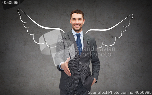 Image of happy businessman with angel wings over gray