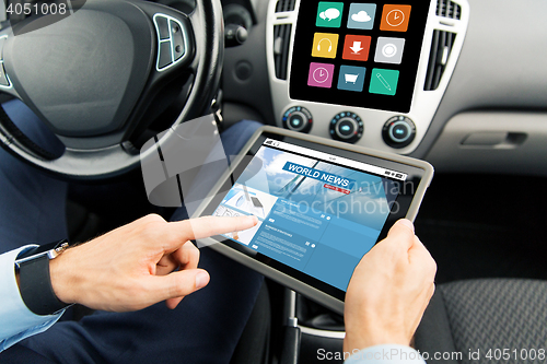 Image of close up of man with tablet pc in car