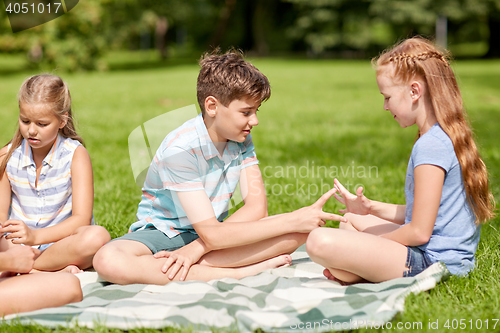 Image of happy kids playing rock-paper-scissors game