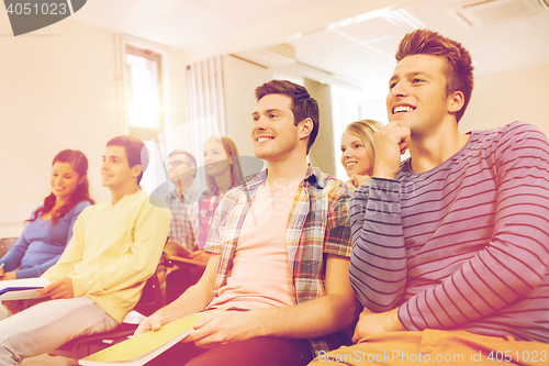 Image of group of smiling students in lecture hall