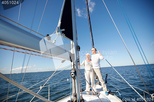 Image of senior couple hugging on sail boat or yacht in sea