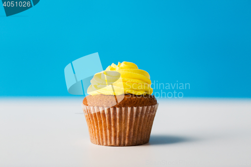 Image of close up of cupcake or muffin with icing on table