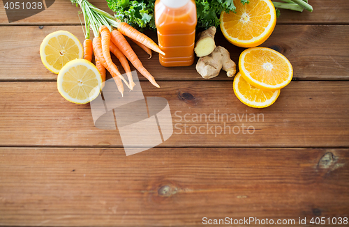 Image of bottle with carrot juice, fruits and vegetables