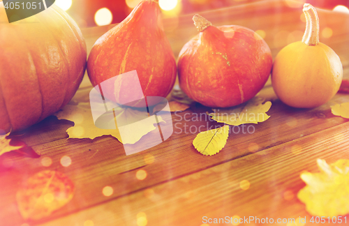 Image of close up of pumpkins on wooden table at home