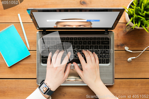 Image of close up of woman with internet search on laptop