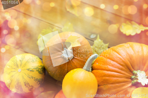 Image of close up of pumpkins on wooden table at home