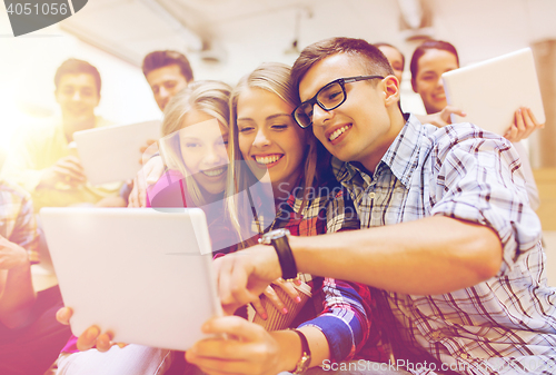 Image of group of smiling students with tablet pc