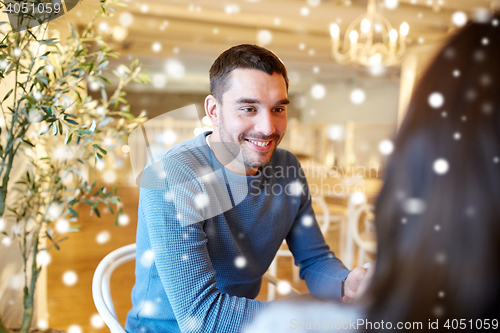 Image of happy couple talking at cafe or restaurant