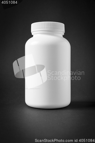 Image of white plastic jar isolated on black