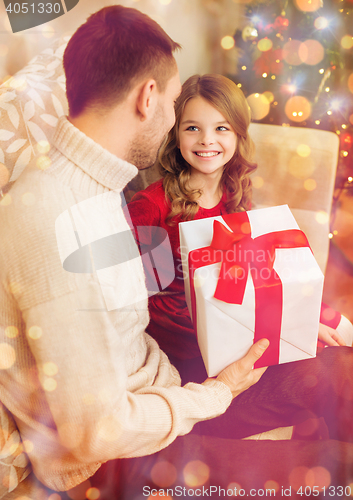 Image of smiling father and daughter looking at each other