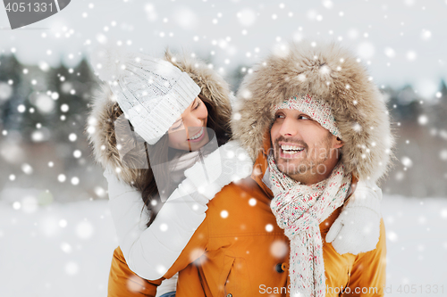 Image of happy couple having fun over winter background