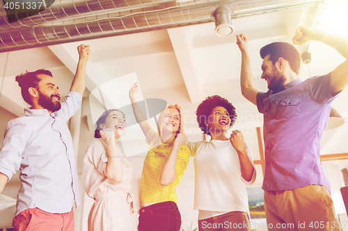 Image of happy creative team in office