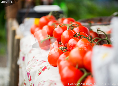 Image of close up of ripe red tomatoes at street market