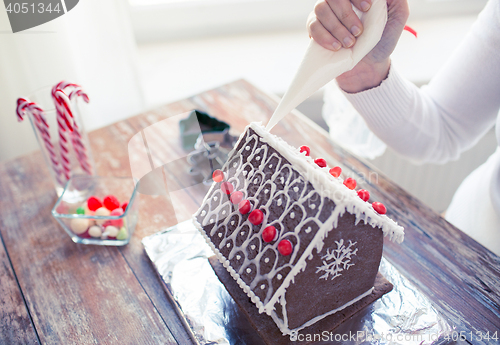 Image of close up of woman making gingerbread houses