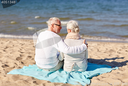 Image of happy senior couple hugging on summer beach