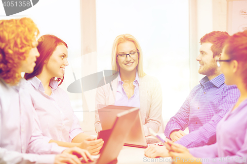 Image of smiling team with laptop and table pc computers