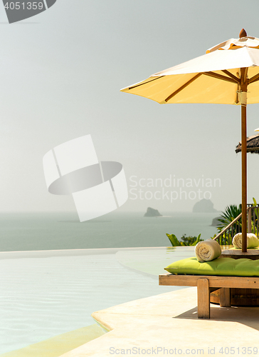 Image of view from infinity edge pool with parasol to sea