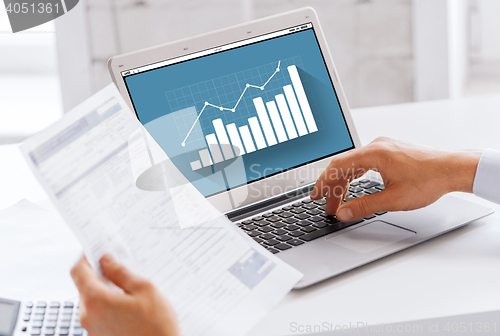 Image of businessman with laptop computer working at office