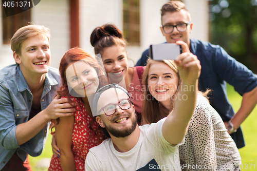 Image of friends taking selfie by smartphone at summer