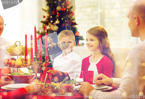 Image of smiling family having holiday dinner at home