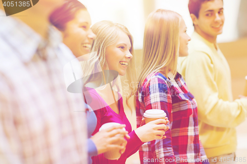 Image of group of smiling students with paper coffee cups
