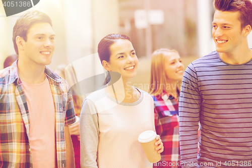 Image of group of smiling students with paper coffee cups