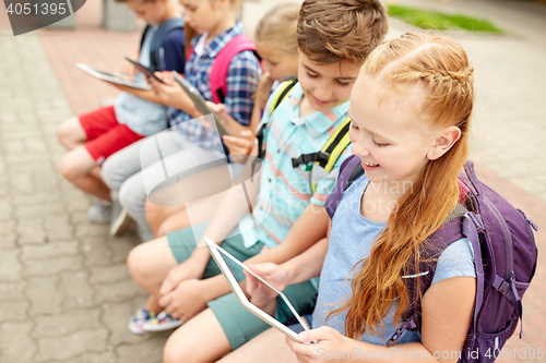Image of group of happy elementary school students talking