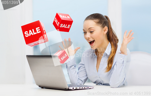 Image of surprised businesswoman with laptop and sale signs