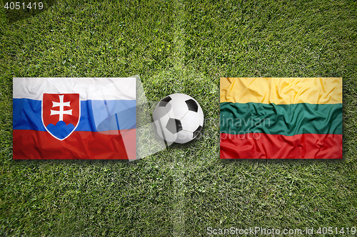 Image of Slovakia vs. Lithuania flags on soccer field