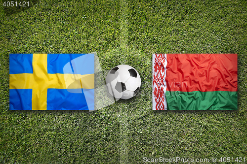 Image of Sweden vs. Belarus flags on soccer field