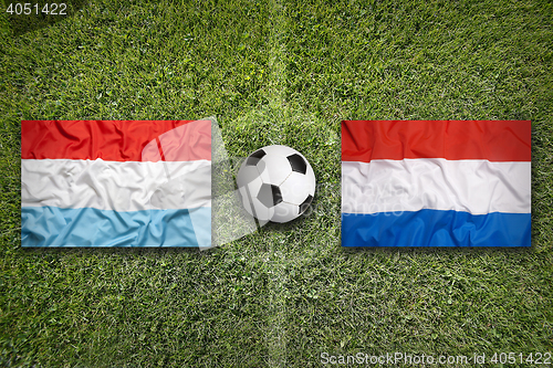 Image of Luxembourg vs. Netherlands flags on soccer field