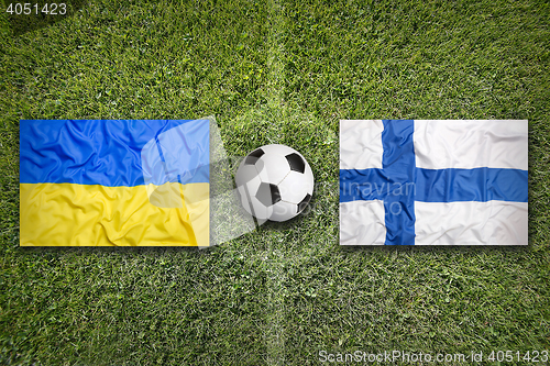 Image of Ukraine vs. Finland flags on soccer field