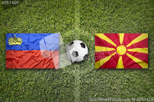 Image of Liechtenstein vs. Macedonia flags on soccer field