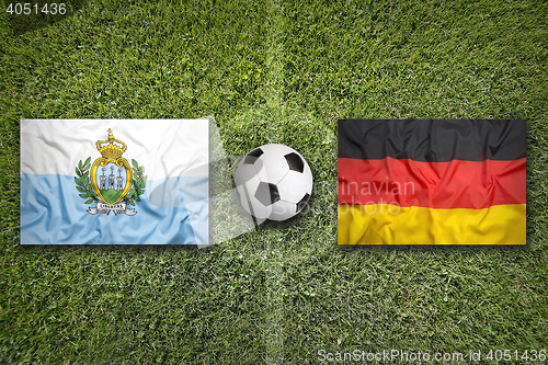 Image of San Marino vs. Germany flags on soccer field