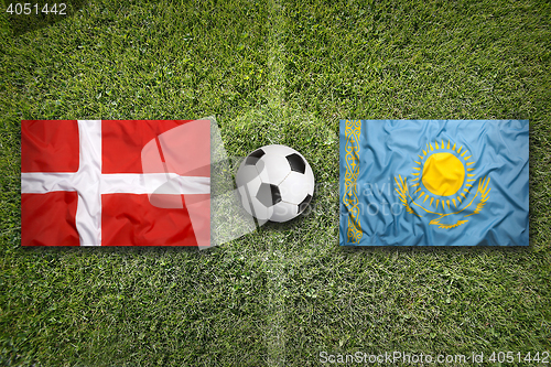 Image of Denmark vs. Kazakhstan flags on soccer field