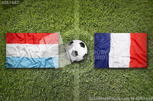 Image of Luxembourg vs. France flags on soccer field