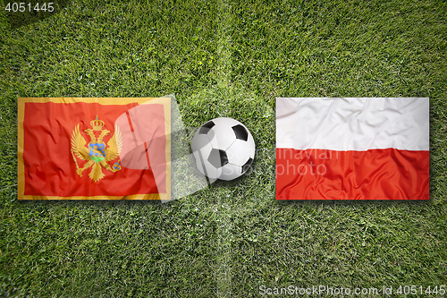 Image of Montenegro vs. Poland flags on soccer field