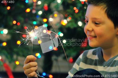 Image of Young boy holding  sparkler 