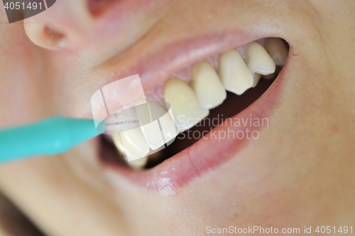 Image of A Woman Cleaning Her Teeth