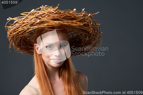 Image of Smiling beautiful woman in natural wreath