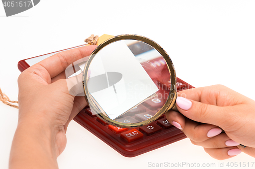 Image of Concept for Internet shopping: hands with Magnifier and price tag