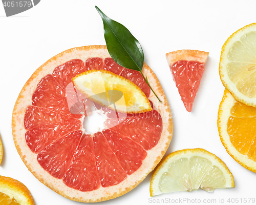 Image of Fresh citrus fruits slices background viewed from above.