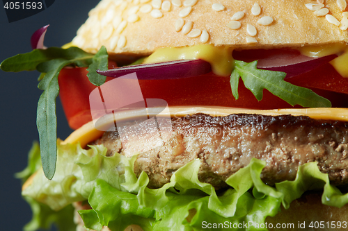 Image of Fresh burger with beef, cheese and tomatoes.