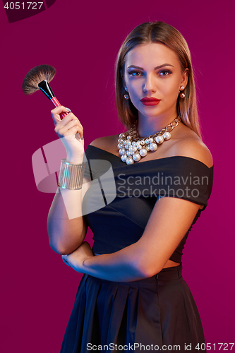 Image of Woman makeup artist standing with brush