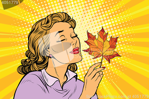 Image of Girl and autumn, a woman with red maple leaf